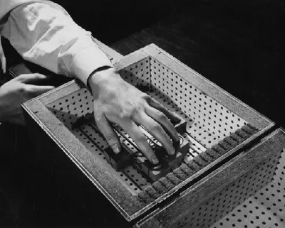 Close-up of hand operating an early electronic computing device