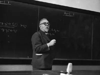 Wiener lecturing at a chalkboard with equations dated April 1