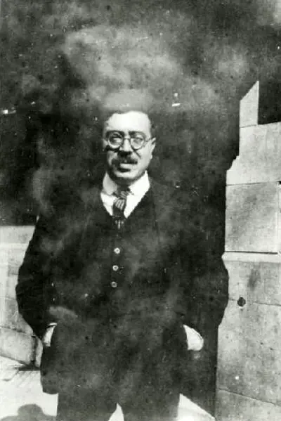 Wiener standing outdoors in overcoat with hands in pockets