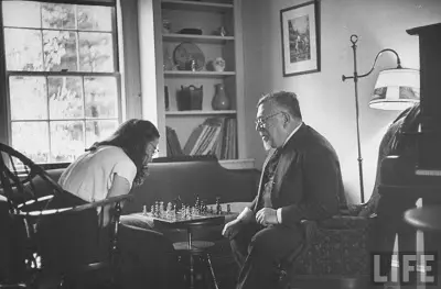 Wiener playing chess at home with a young woman, from LIFE magazine
